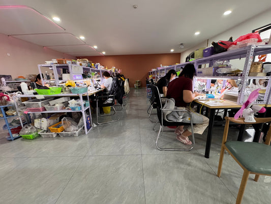 Velnora press-on nail production workshop with artisans working at nail stations